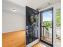 Inviting entryway with hardwood floors, a colorful wreath on the door, and ample natural light streaming in at 14500 Harvington Dr, Huntersville, NC 28078