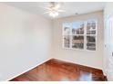 Bright bedroom featuring hardwood floors and a large window with neighborhood views at 16812 Lookout Landing Ln, Charlotte, NC 28278
