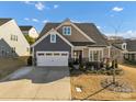 Charming two-story home with a well-manicured lawn and an attached two-car garage at 16812 Lookout Landing Ln, Charlotte, NC 28278