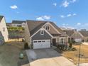 Charming two-story home with a well-manicured lawn and an attached two-car garage at 16812 Lookout Landing Ln, Charlotte, NC 28278