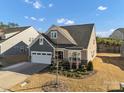 Charming two-story home with a well-manicured lawn and an attached two-car garage at 16812 Lookout Landing Ln, Charlotte, NC 28278