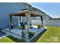 Covered patio with pergola, comfortable seating area, and well-manicured lawn at 171 Crownpiece St, Troutman, NC 28166