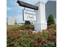 Weather Creek community entrance with brick sign and beautiful landscaping at 171 Crownpiece St, Troutman, NC 28166