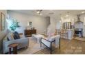 Open living room with a modern sofa, coffee table, and kitchen island at 339 East Blvd, Charlotte, NC 28203