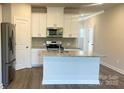 Modern kitchen featuring stainless steel appliances, granite countertops, and a kitchen island at 3500 Backwater St, Concord, NC 28027