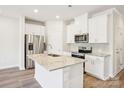 Modern kitchen with stainless steel appliances, granite countertops, and white cabinets at 3500 Backwater St, Concord, NC 28027