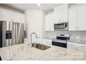 Open kitchen with an island sink, stainless steel appliances, and granite countertops at 3500 Backwater St, Concord, NC 28027