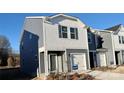 Gray and white two-story townhome with a white garage door and landscaping at 3530 Backwater St, Concord, NC 28027