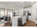 Modern kitchen with white cabinets, stainless steel appliances, and an island at 3530 Backwater St, Concord, NC 28027