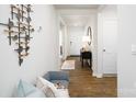 Home hallway with seating area, wood flooring, and modern wall art at 4614 Harris Elliot Rd, Lincolnton, NC 28092