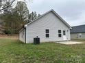 Gray house side with a small patio at 53 Soloman St, Wadesboro, NC 28170