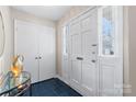 Bright foyer with tiled floors, closet, and glass table creates an inviting entry at 7000 Quail Hill Rd, Charlotte, NC 28210
