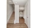 Welcoming entryway featuring hardwood-style floors, staircase and neutral paint at 828 Renee Ave, Fort Mill, SC 29715
