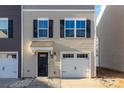 Charming two-story home featuring a one-car garage and a welcoming front door at 828 Renee Ave, Fort Mill, SC 29715