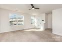 Bright living room with a ceiling fan, neutral carpet, and lots of natural light at 828 Renee Ave, Fort Mill, SC 29715