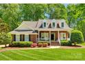 Brick house with a front porch and American flag at 908 Thorn Ridge Ln, Lake Wylie, SC 29710