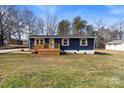 Newly renovated home with blue siding, wood deck, and landscaped lawn at 126 Terrace Dr, Bessemer City, NC 28016