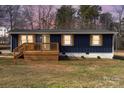 Newly renovated home with blue siding, wood deck, and landscaped lawn at 126 Terrace Dr, Bessemer City, NC 28016