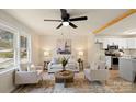 Cozy living room boasts a modern ceiling fan, natural light, and seamlessly connects to the kitchen at 126 Terrace Dr, Bessemer City, NC 28016