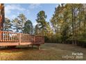 Wooden deck overlooking a spacious backyard and trees at 14226 Carlton Woods Ln, Charlotte, NC 28278