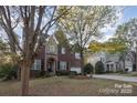 Two story home with landscaping and a neighboring house visible at 14226 Carlton Woods Ln, Charlotte, NC 28278