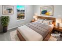 Virtually staged bedroom with wood bed frame and large window at 14602 Lions Paw St, Charlotte, NC 28273
