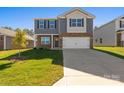Attractive home featuring gray siding, stone accents, a two-car garage, and a well-maintained front yard at 1758 Falls Cove Rd, Newton, NC 28658