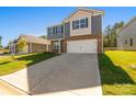 Charming home featuring gray siding, stone accents, a two-car garage, and long driveway at 1758 Falls Cove Rd, Newton, NC 28658