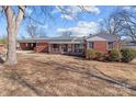 Ranch house with carport and mature trees at 200 11Th St, Spencer, NC 28159