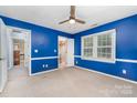 Inviting blue bedroom featuring a cozy carpet, natural light, ample closet space, and neutral trim at 2000 Shannon Bridge Ln, Matthews, NC 28105