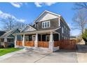 Charming two-story home with a welcoming front porch and wooden fence at 212 Bacon Ave, Charlotte, NC 28208