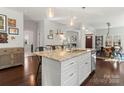 Open-concept kitchen with a granite island, stainless steel appliances, and hardwood floors at 212 Bacon Ave, Charlotte, NC 28208