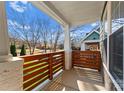 Covered porch with wooden railings and a view of the neighborhood at 212 Bacon Ave, Charlotte, NC 28208
