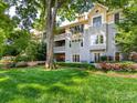 Condo building's backyard features lush greenery and large trees at 308 Queens Rd # 25, Charlotte, NC 28204