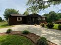 Long driveway to a cozy single-story home with mature landscaping and plenty of parking space at 3510 Flint Dr, Statesville, NC 28677