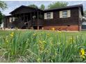 Charming single-story home with lovely flowerbeds and a cozy front porch creates a welcoming curb appeal at 3510 Flint Dr, Statesville, NC 28677