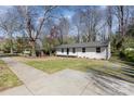 Attractive house with a freshly painted exterior, a new roof, large front yard and sidewalk access at 3843 Foxford Pl, Charlotte, NC 28215