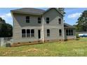 Rear view of the house, showcasing a large yard and windows at 6024 Lake Rd, Mint Hill, NC 28227