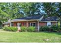 Beautiful brick home with a covered porch and well-maintained landscaping at 7740 Robinson Church Rd, Charlotte, NC 28215