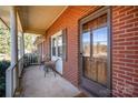 Brick front porch with seating and a view of the street at 7740 Robinson Church Rd, Charlotte, NC 28215