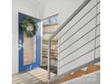 Modern entryway with blue door, metal railing, and hardwood floors at 914 Greenleaf Ave # B, Charlotte, NC 28202