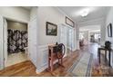 Hallway with hardwood floors, white trim and a view of the open-concept floor plan at 1007 Orchid Ln, Fort Mill, SC 29707