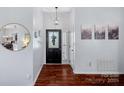 Inviting foyer with hardwood floors, decorative lighting, and a view into the living areas at 11414 Coreopsis Rd, Charlotte, NC 28213