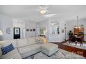 Open-concept living room with a large sofa, hardwood floors, and seamless flow to other rooms at 11414 Coreopsis Rd, Charlotte, NC 28213