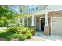 Inviting front porch with stone pillars, well manicured shrubs, and blue outdoor chairs at 117 Tomahawk Dr, Mooresville, NC 28117