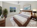 Virtually staged bedroom with a king-size bed and large window at 133 Jacobs Woods Cir, Troutman, NC 28166