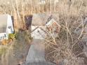 Two-story house, aerial view showcasing driveway and surrounding trees at 13443 Norseman Ln, Huntersville, NC 28078