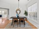 Dining area with modern table, chairs, and a chandelier at 13443 Norseman Ln, Huntersville, NC 28078