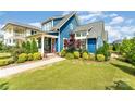 Charming blue home with a well-manicured lawn and a vibrant pink front door at 1575 Riverwalk Pkwy, Rock Hill, SC 29730