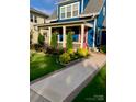 Welcoming front porch and walkway leading to a charming blue house at 1575 Riverwalk Pkwy, Rock Hill, SC 29730